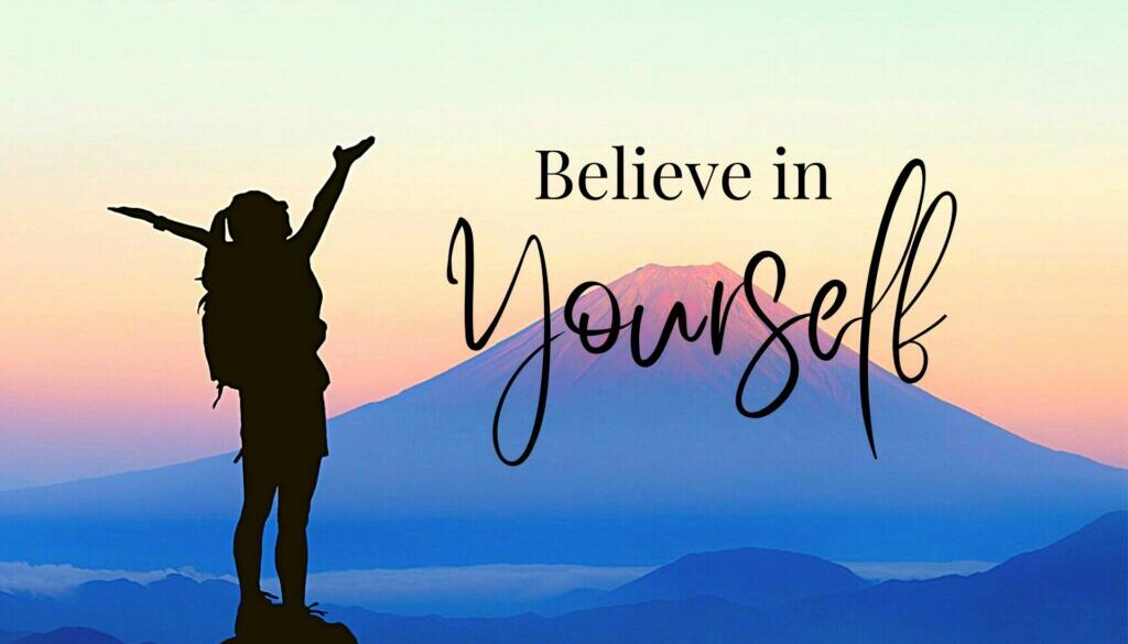 silouhette of girl with arms raised opposite a mountain with words Believe in yourself